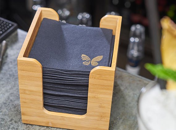 Custom branded cocktail napkin with napkin dispenser