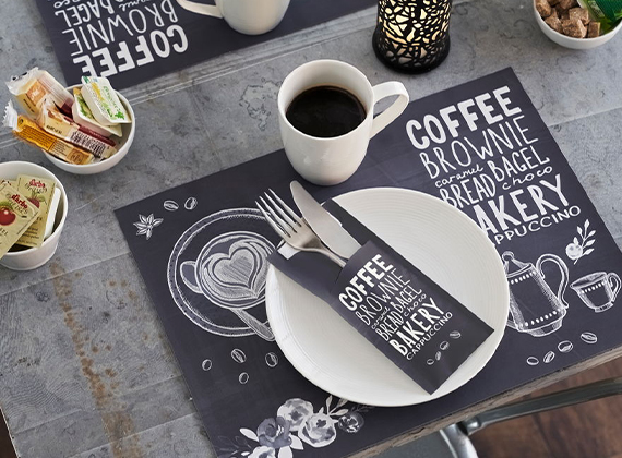 Printed dark blue napkin pocket on table with coffee
