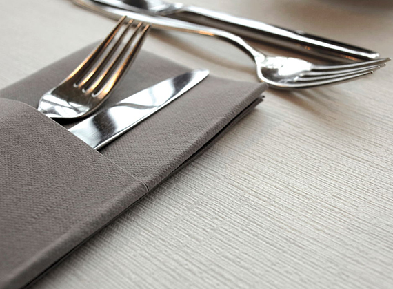 Close up shot of grey cutlery napkin pocket with cutlery