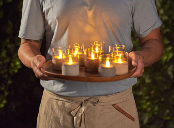 Waiter holding moving flame LED candle lights