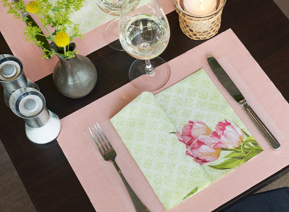 Pastel coloured napkin on a pink placemat