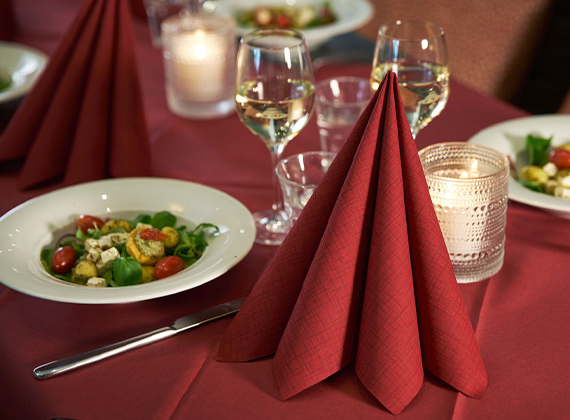 Red linen feel napkin folded on restaurant table