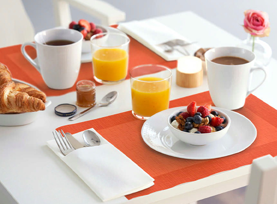 Bright orange placemat at breakfast service