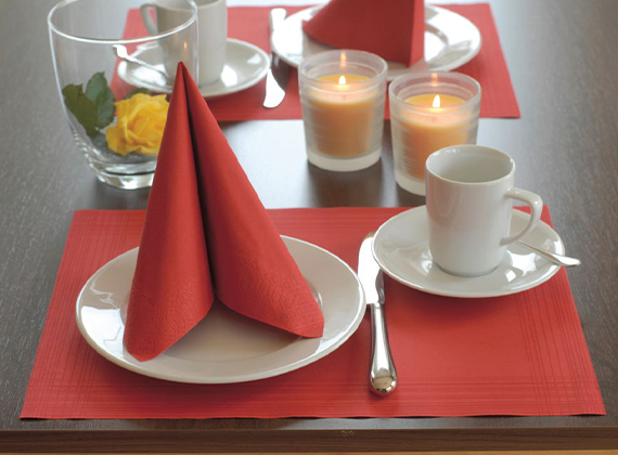 Red placemat for breakfast service with matching tissue napkin