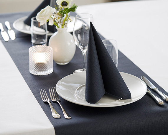 Black table runner and napkin on banquet table with cutlery