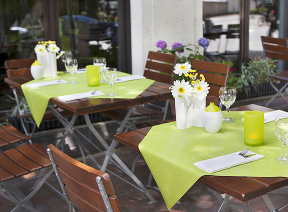 Green slipcover on outside terrace for outdoor dining